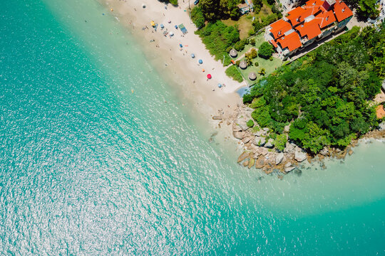 Sandy beach with villas and turquoise ocean in Florianopolis, Brazil. Aerial view