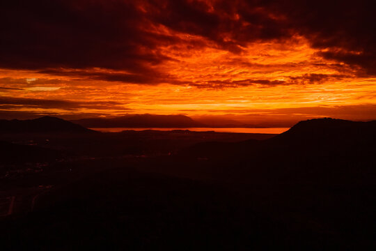 Sunset with amazing clouds and silhouette of coastline in Florianopolis, Brazil