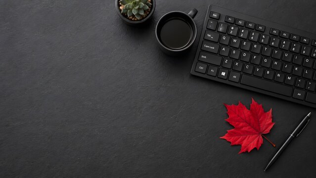 Minimalist black workspace with computer keyboard and red maple leaf, dark office desk with coffee cup and pen, autumn business background