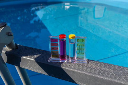 Pool Water pH and Chlorine Tester Kit on Blue Pool Ledge