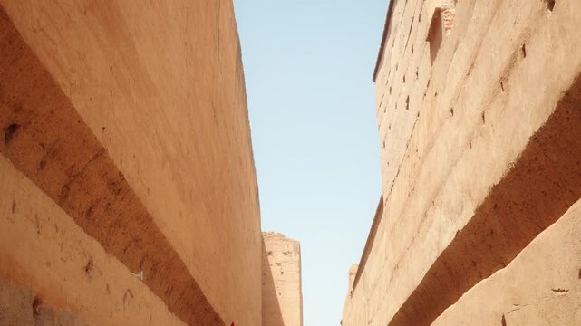 Sunlit Narrow Alley Between Adobe Walls Of Historic Kasbah With Clear Blue Sky Overhead