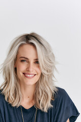 Fototapeta premium radiant young woman with platinum blonde hair and hazel eyes, natural beauty portrait of smiling freckled woman in sunlight, elegant female model with silver blonde waves and warm glowing skin