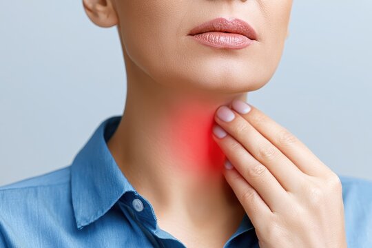 Woman touches neck to thyroid gland disease symptoms. Glowing red sign on throat. Endocrine inflammation hypothyroidism goiter node or larynx pain. Lymph node screening, hormones. Awareness campaign