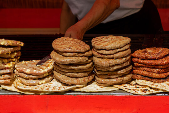 Pile of beef meat hamburgers grilled and sold outside on local fair