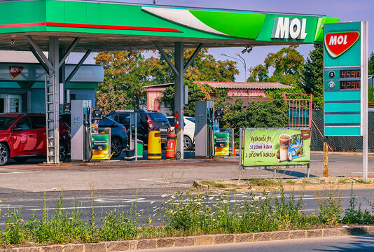 Prague, Czech Republic - August 1, 2026: MOL fuel station with multiple vehicles at fuel pumps, branded canopy, price board, and everyday refueling activity at a modern service station.