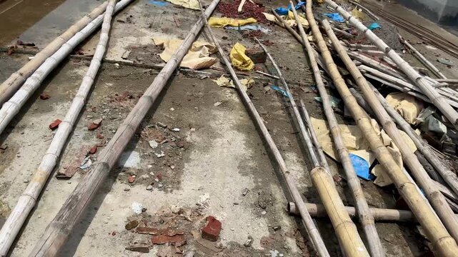 Bamboo Poles and Materials Scattered at Concrete Construction Site