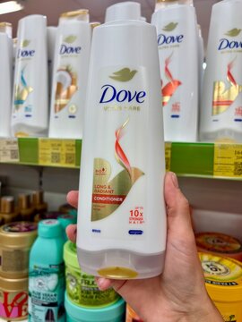 01.08.2026 Ukraine, Kharkov Woman Holding Dove Hair Conditioner Bottle in Store