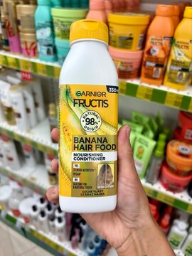 01.08.2026 Ukraine, Kharkov Woman Holding Garnier Fructis Banana Hair Food Conditioner