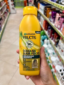 01.08.2026 Ukraine, Kharkov Woman Holding Garnier Fructis Banana Hair Food Shampoo