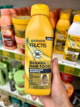 01.08.2026 Ukraine, Kharkov Woman Holding Garnier Fructis Banana Hair Food Shampoo