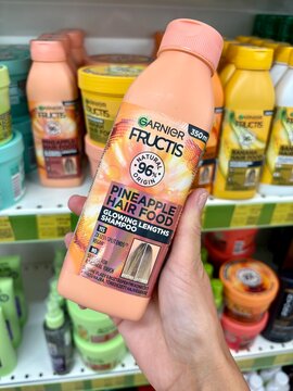 01.08.2026 Ukraine, Kharkov Woman Holding Garnier Fructis Pineapple Hair Food Shampoo