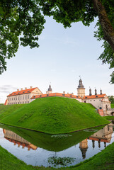 Naklejka premium Historic castle reflects across tranquil water