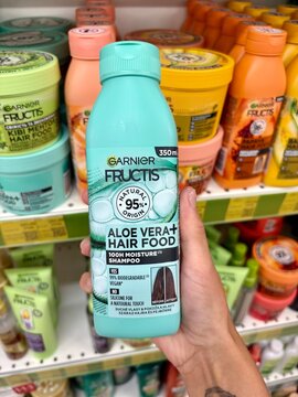 01.08.2026 Ukraine, Kharkov Woman Holding Garnier Fructis Aloe Vera Hair Food Shampoo