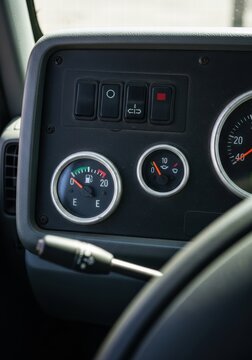 Detailed view of a vehicle's control panel featuring various gauges and toggle switches for operation and monitoring