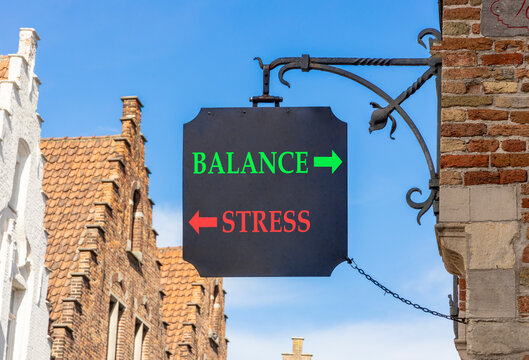 Balance instead stress words symbol. Concept words Balance Stress on beautiful black road sign. Beautiful blue sky background. Business medical psychology balance stress concept. Copy space.