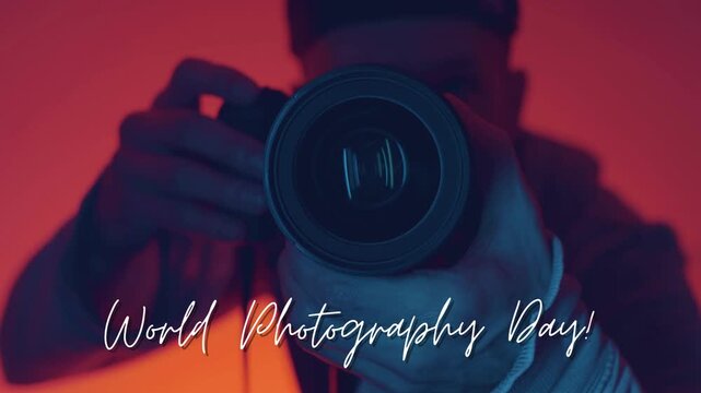 Slow motion footage of a photographer aiming a camera lens for world photography day celebration
