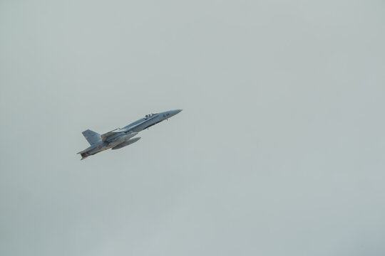 Albacete, Spain - June 12, 2026: An F 18 fighter jet flying upwards against a gray sky over Los Llanos Air Base