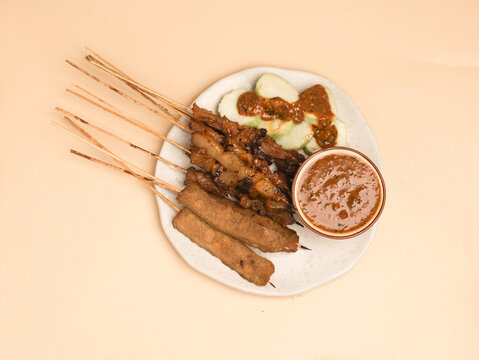 Sate Kere is popular street food in Java, Indonesia, made from grilled tempeh and cow innards, served with peanut sauce