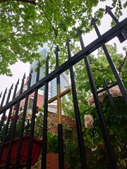 Fototapeta premium Pink Roses on Wrought Iron Fence with Glass Dome Building