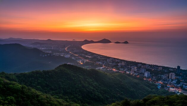 Sunset view of the coastal Visakhapatnam city skyline from a high vantage point vanta over the ocean bay for travel destination and urban growth concept