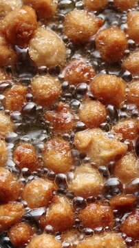 Deep-frying textured vegetable protein chunks or soy meat in hot bubbling oil. Plant-based food