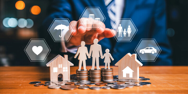 Professional businessman planning family financial security and insurance investment with coins and miniature houses