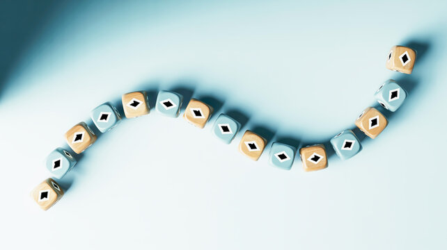Abstract composition of blue and orange cubic beads arranged in a winding wave pattern on a pale blue surface