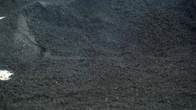 Metal Shovel Distributing Hot Asphalt During Roadwork