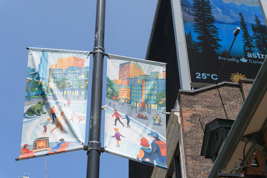 winter themed, pole mounted BIA banners near Sankofa Square, Toronto (with an Astral Media designated digital billboard with weather stamp)