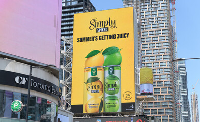 Fototapeta premium digital ad for Simply Spiked hard lemonade, a product of Molson Coors Beverage Company, facing Sankofa Square, Toronto
