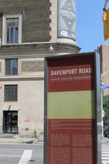 Fototapeta premium wayfinding location marker at Davenport Road and Yonge St with defocused view of The Masonic Temple (1917) at 888 Yonge St, Toronto