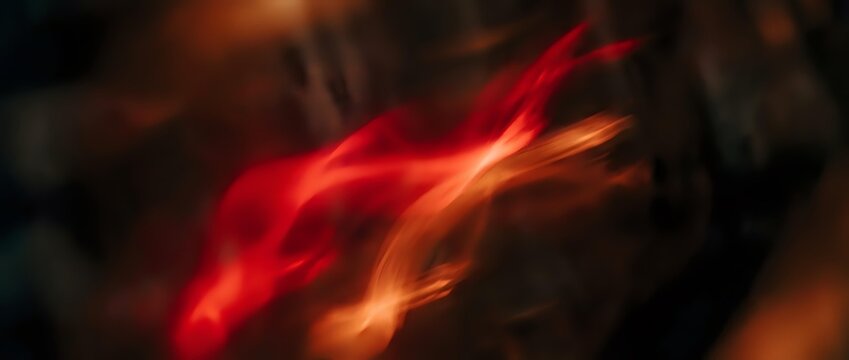 Glowing red and orange flames swirl dynamically against a dark background, creating an intense fire effect suitable for motion graphics, visual effects, and multimedia projects.