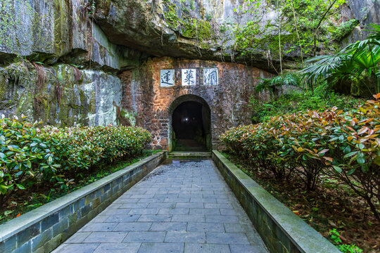 Guniujiang Penglai Cave Entrance: Stone Path Leads to Mystical Grotto Amid Lush Greenery