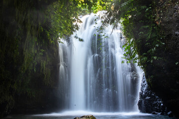 Fototapeta premium A very beautiful and refreshing view of a waterfall in Central Lombok on a bright and cool afternoon.