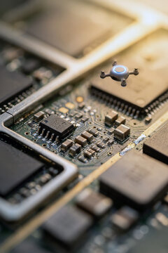 Miniature drone hovering over a computer circuit board