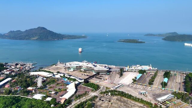 Bakauheni ferry port in Lampung, Sumatra, Indonesia during daytime. Ro-Ro ships docking and transporting vehicles across the Sunda Strait.
