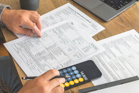 Man using phone calculator for tax preparation