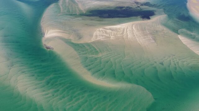 Currents from the Atlantic Ocean continuously shape the sand bars and scenic beaches of Cape Cod, Massachusetts. The entire peninsula is in constant movement due to its geologic makeup of mostly sand.
