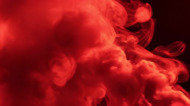 Abstract red cloud formation against a dark background.