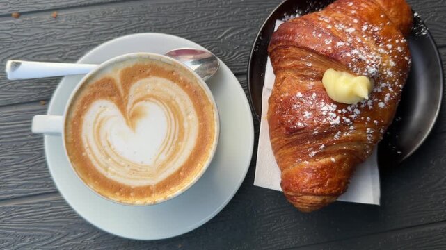cup of cappuccino with croissant
