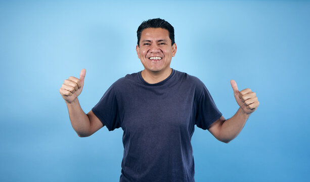 portrait of adult latin man in blue background in Mexico Latin America