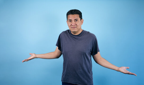 portrait of adult latin man in blue background in Mexico Latin America