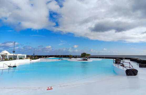 Arrecife, Lanzarote, Spain - December 17, 2025: Saltwater swimming pool at Islote de Fermina, a waterfront leisure complex designed by Cesar Manrique and restored as a public space