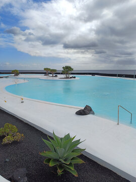 Arrecife, Lanzarote, Spain - December 17, 2025: Saltwater swimming pool at Islote de Fermina, a waterfront leisure complex designed by Cesar Manrique and restored as a public space
