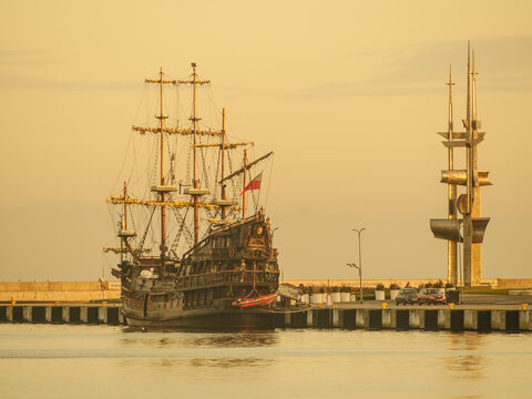 Sails monument and pirate ship on coastal promenade in city Gdynia.,18 December 2025, Poland