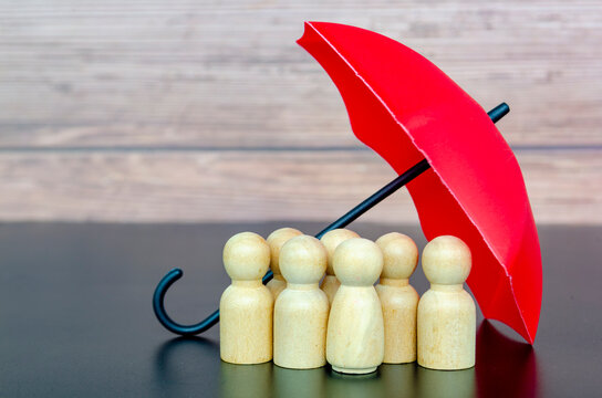 Red umbrella protecting wooden figures representing leadership, insurance coverage, and security support for followers.