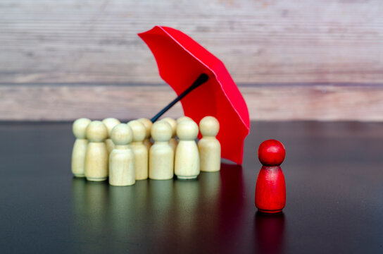 Focus on leadership protection concept showing umbrella coverage for followers through insurance and safety measures.