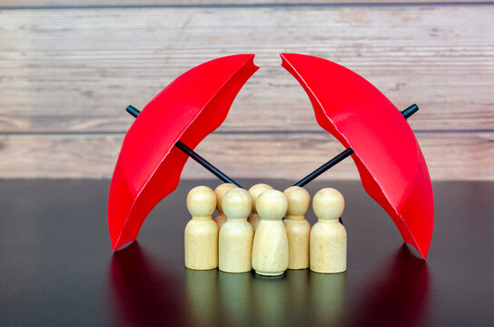Red umbrellas guarding wooden figures symbolizing reliable leadership, safety, and risk protection.