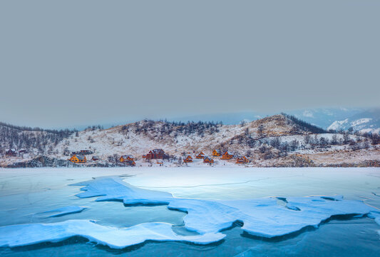 Panorama view of Baikal lake and the village houses with beautiful mountainous behind Baikal lake in winter - Baikal, Siberia