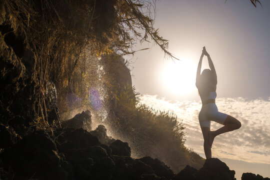 Yoga Pose at Sunrise by Waterfall on Madeira Coast